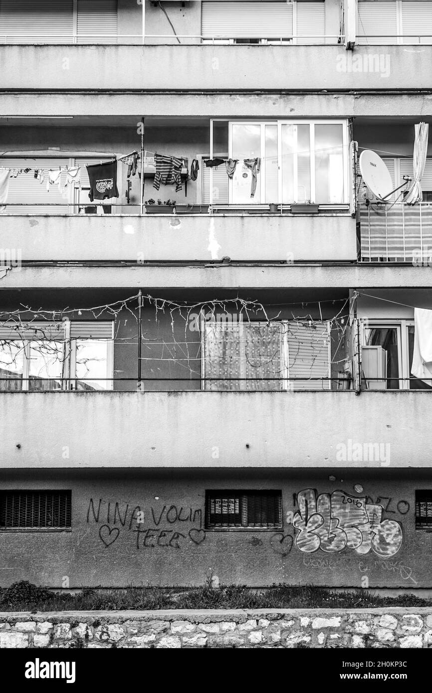 Grayscale shot of terraces of an old apartment building Stock Photo