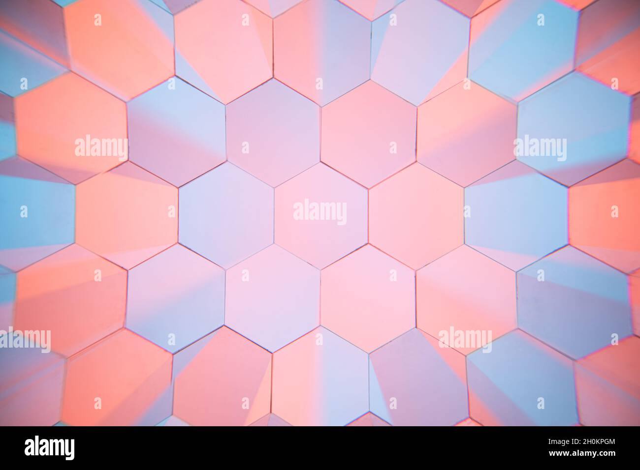 The orange and blue two-color light changes the effect through the six-ling mirror. Hexagonal light effect changing background. Stock Photo