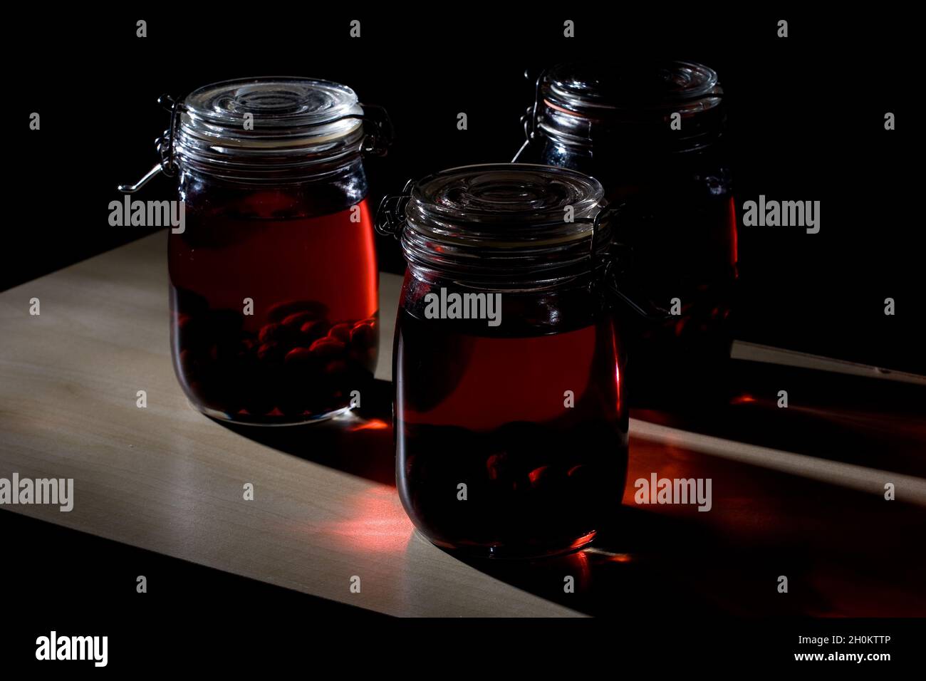 Home made sloe gin maturing and fermenting in kilner jars Stock Photo Alamy