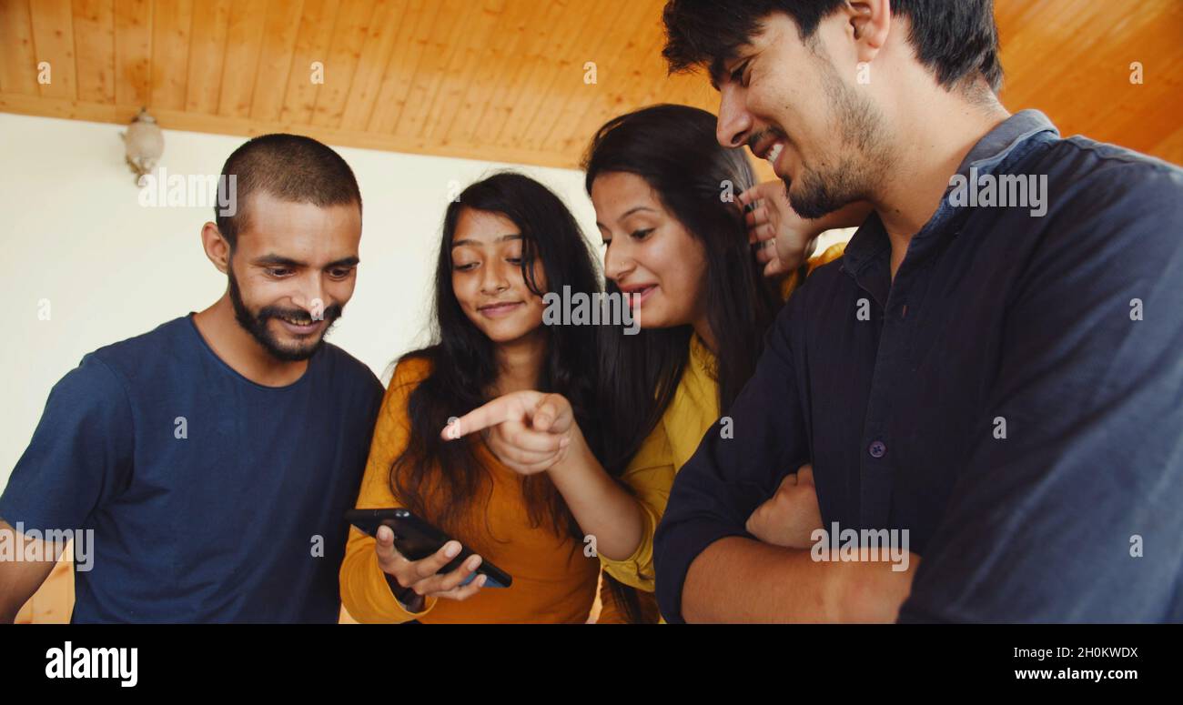 Beautiful young Indian couples looking at the phone and smiling Stock ...