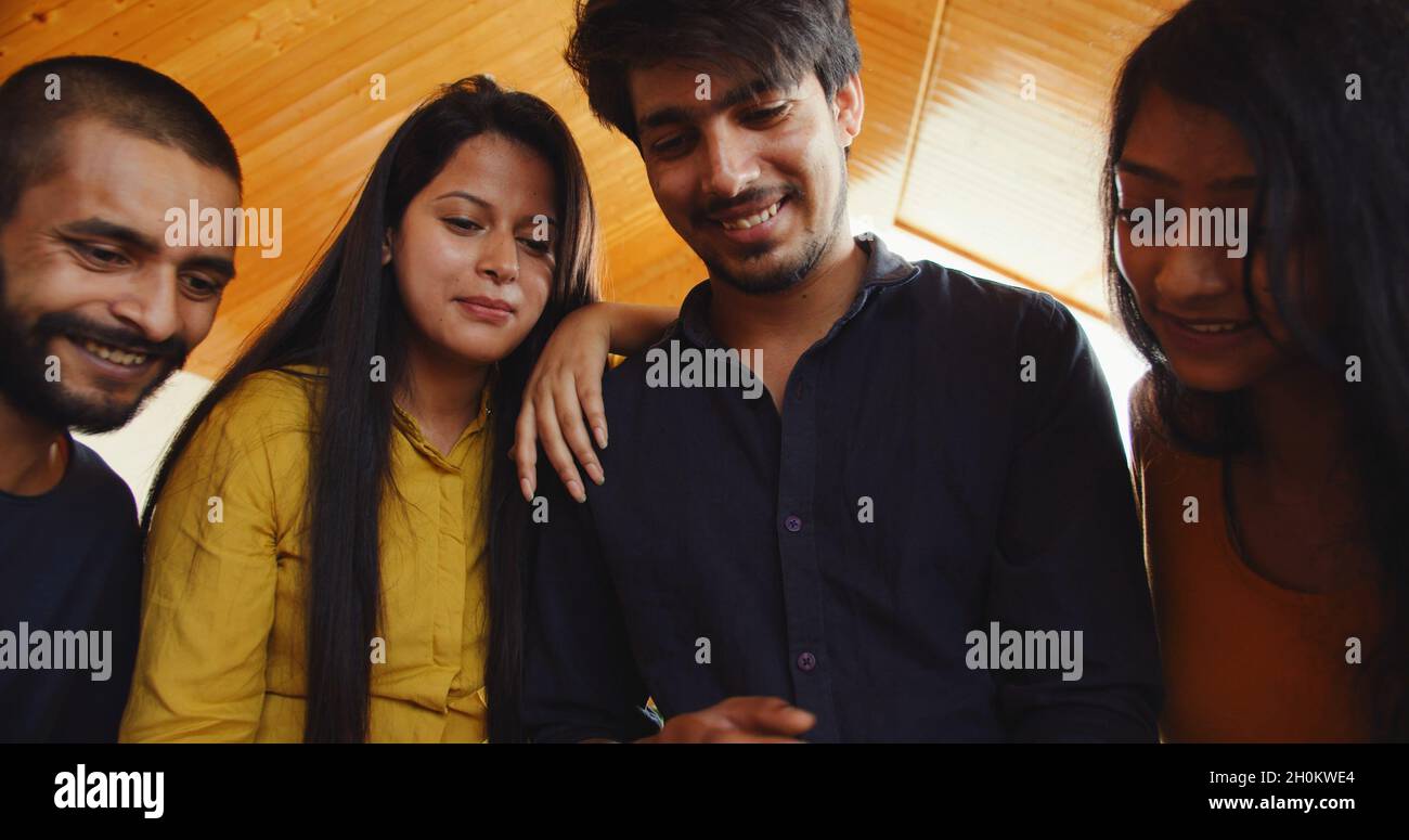 Beautiful young Indian couples looking at the phone and smiling Stock ...