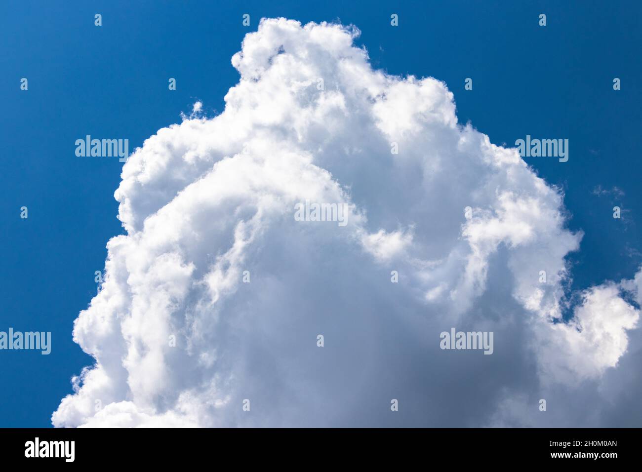 White fluffy clouds on blue hi-res stock photography and images - Alamy