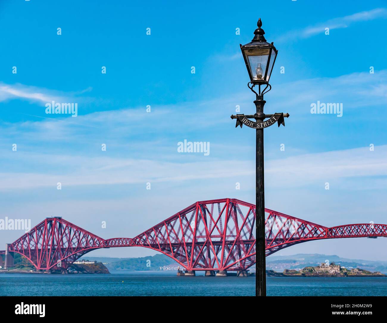 Victorian lamp post with iconic Forth Rail Bridge and Inchgarvie island, South Queensferry, Scotland, UK Stock Photo