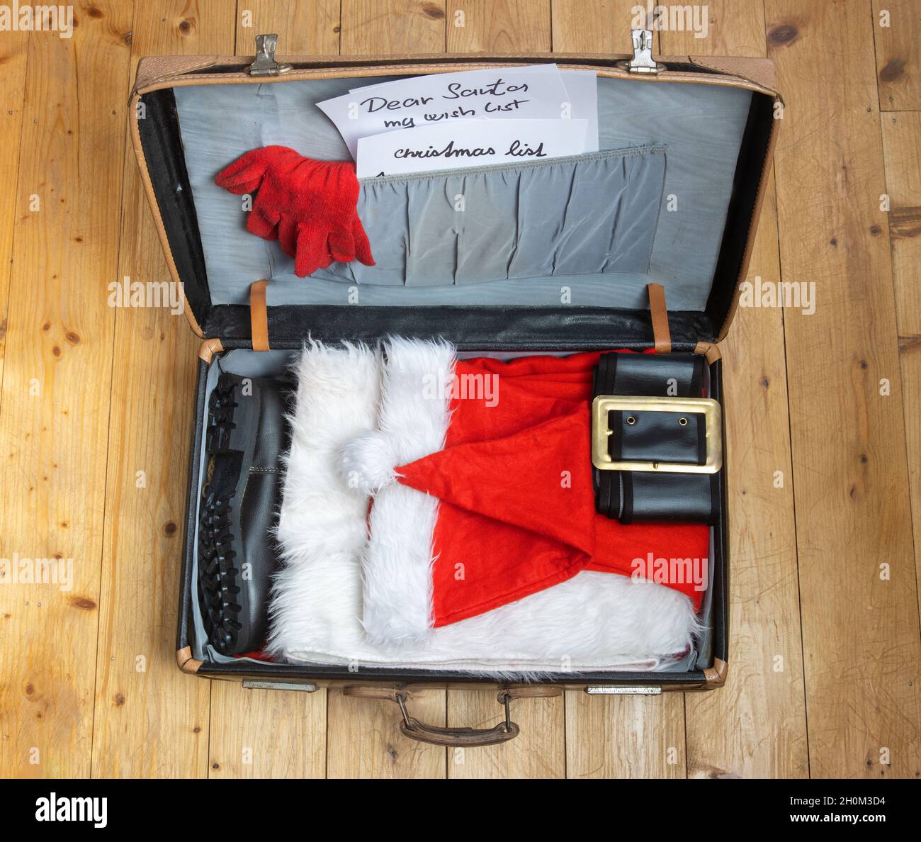 An open suitcase with Santa Claus clothes Stock Photo