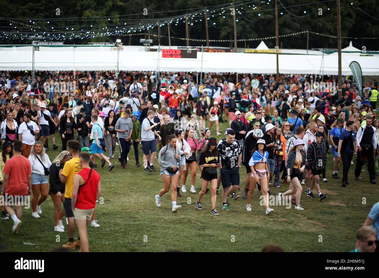 Young people head towards the music stages at the Leeds Festival in west Yorkshire. Young people are being encouraged to get vaccinated whilst attendi Stock Photo