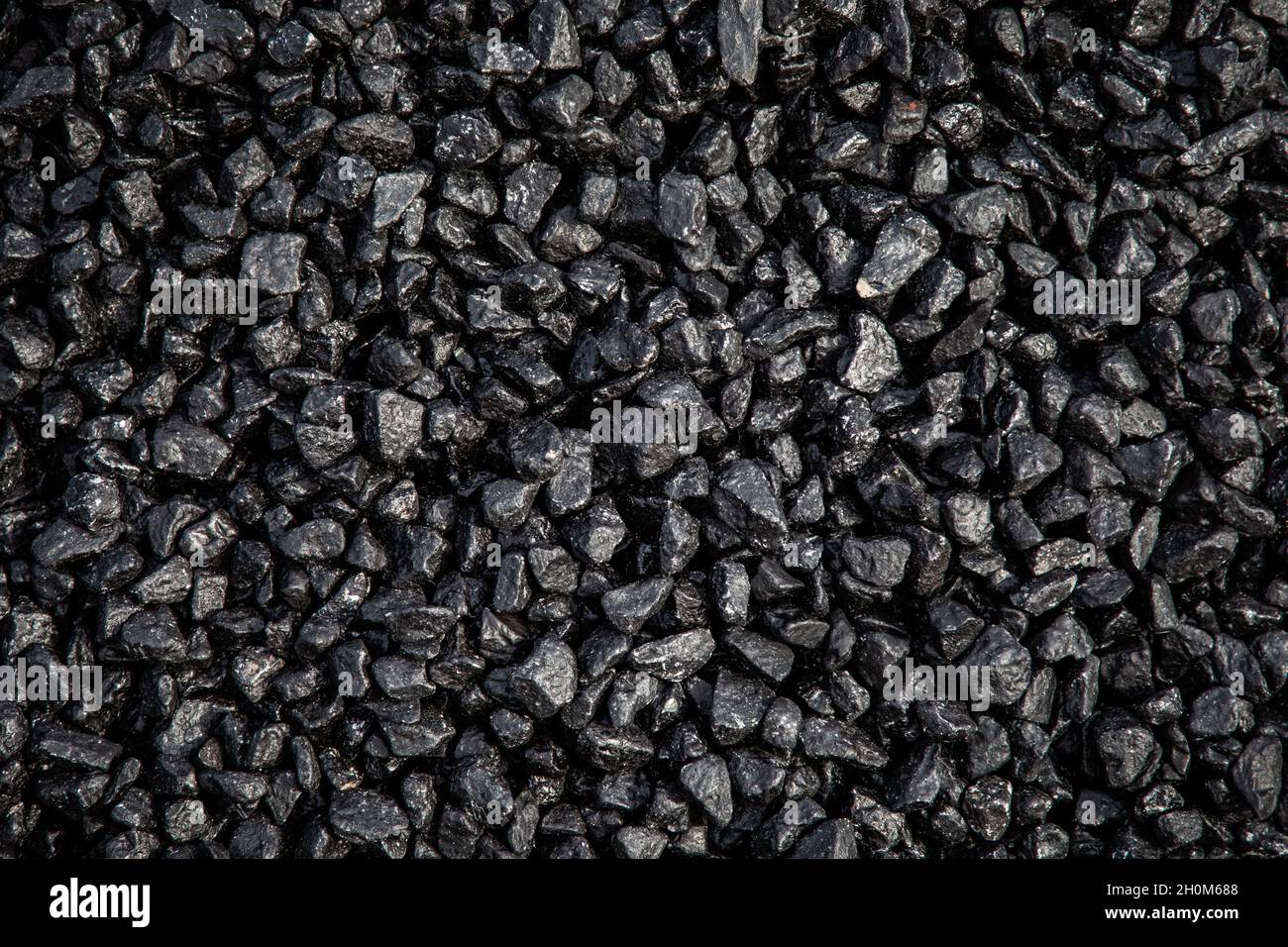 A pile of fresh tarmacadam asphalt waiting to be laid on a road surface Stock Photo