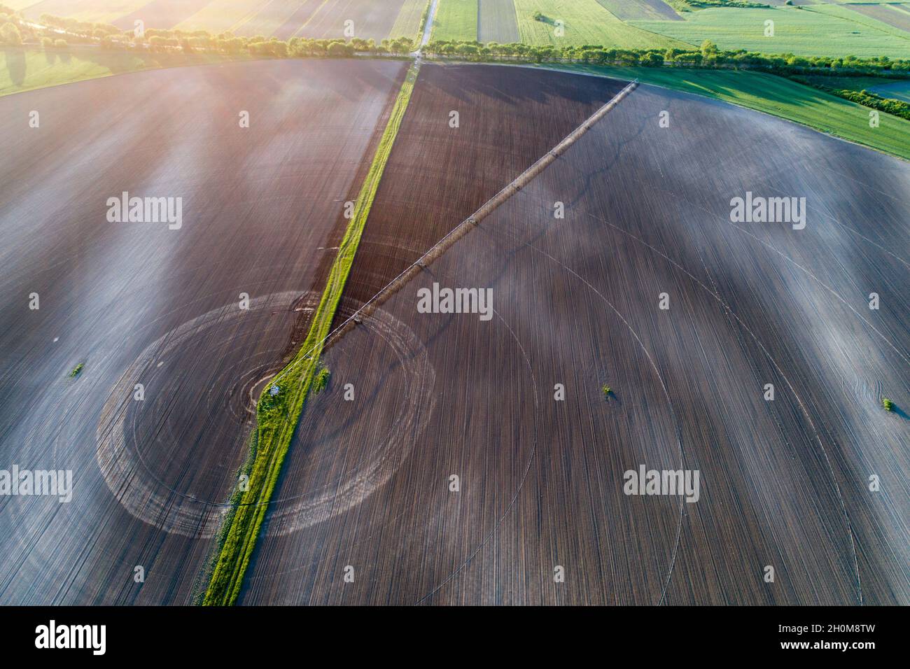 Aerial image of agricultural field with center pivot irrigation systems forming round shape field, shoot from drone Stock Photo