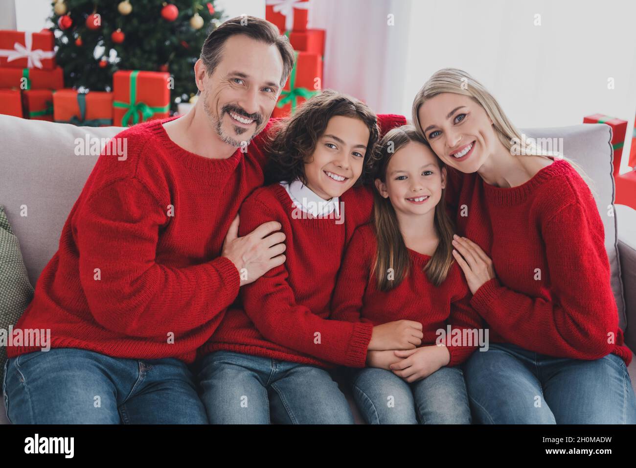 Portrait of careful big full affectionate cheerful family wife husband brother sister sitting on