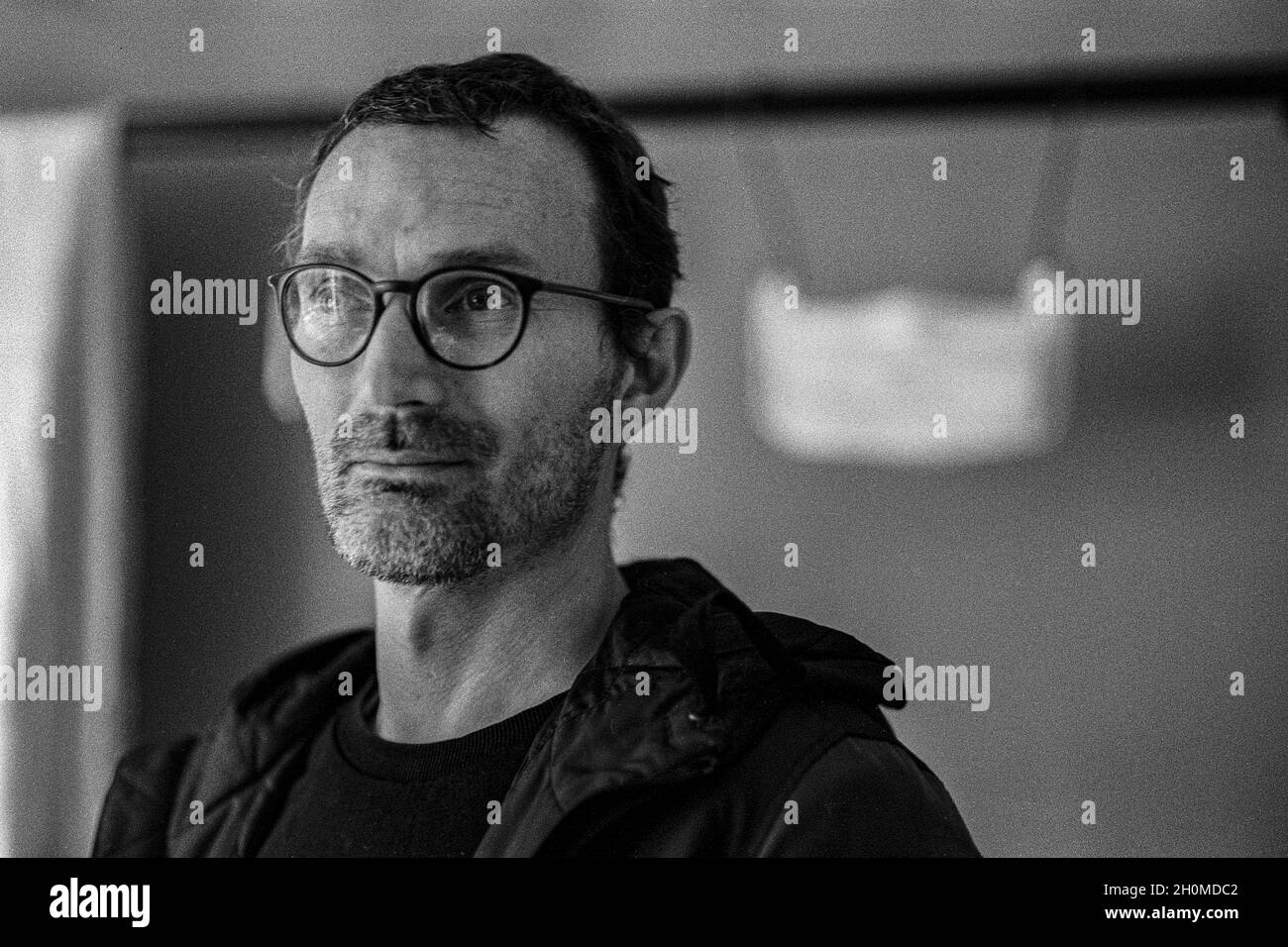 Tilburg, Netherlands. Portrait of man Peter van M in Black & White on Analog Film inside a studio room. Stock Photo