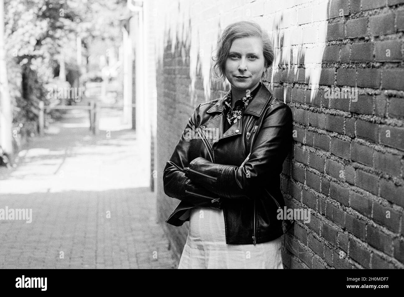 Tilburg, Netherlands. Portrait of a adult, caucasian, blonde woman strolling through down town neigborhoods. Stock Photo