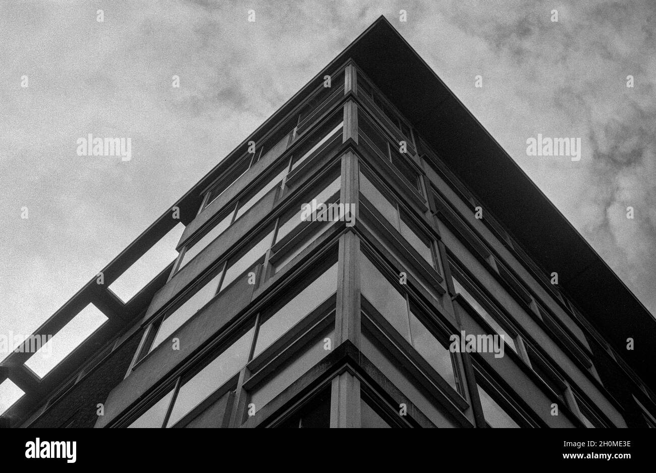 Rotterdam, Netherlands. Corner of a modern apartment building against a claudy, stormy Dutch Sky in Analog Black & White. Collection: gkf-analoog Stock Photo