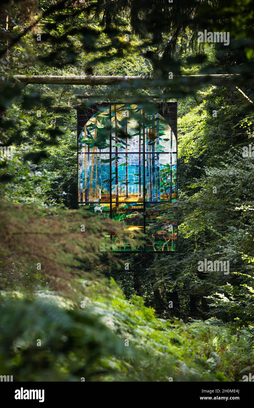 Sunlight on Cathedral, a large hanging stained glass window by aritist Kevin Atherton, part of the Forest of Dean Sculpture Trail. Stock Photo