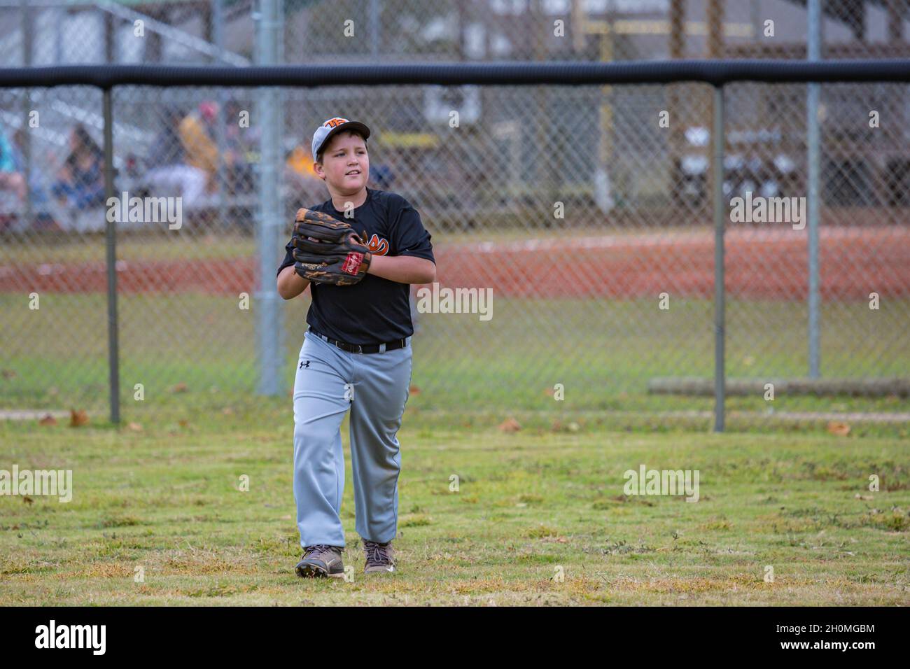 Young pre-teen male playing baseball in uniform Stock Photo