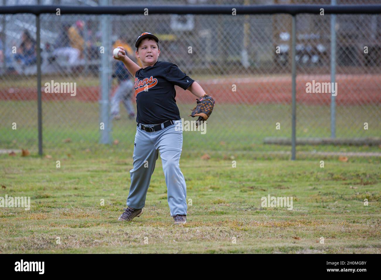 Young pre-teen male playing baseball in uniform Stock Photo