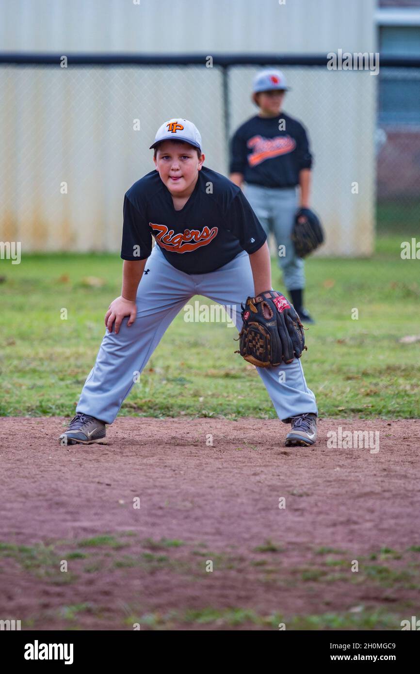 Young pre-teen male playing baseball in uniform Stock Photo