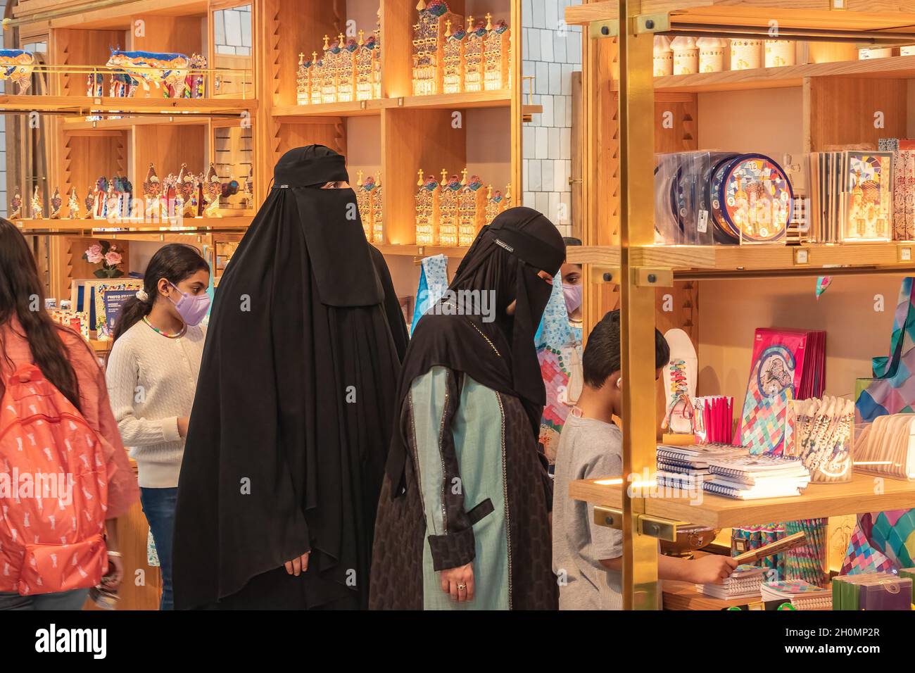 Barcelona, Spain - September 19, 2021: Muslim women wearing a Burka, traditional clothing worn by women in some Islamic countries, are shopping in a s Stock Photo