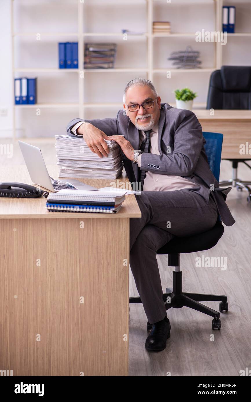 Old businessman employee working at workplace Stock Photo - Alamy