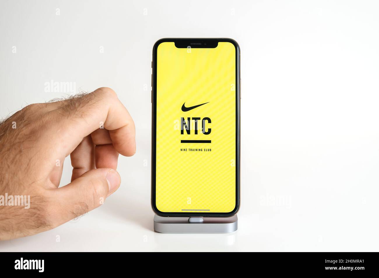 POV male hand touching the new Apple Computers iPhone 13 smartphone with  running NTC Nike Training Club Stock Photo - Alamy