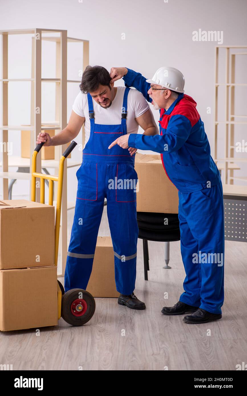 Two professional movers doing home relocation Stock Photo