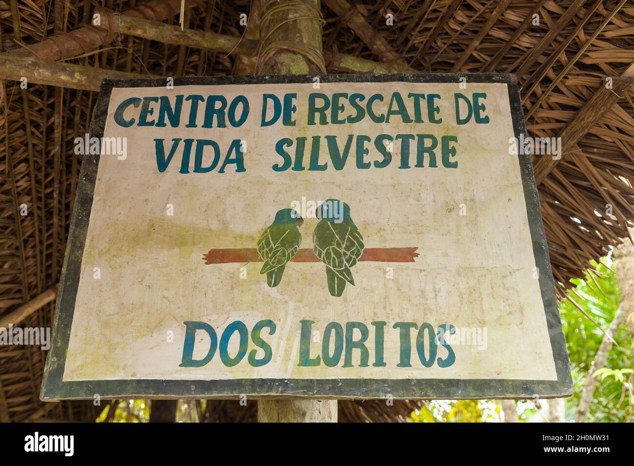 Pilcopata, Peru - April 10, 2014: Old entrance sign to the Dos Loritos wildlife recovery and rescue center, near the small town of Pilcopata Stock Photo