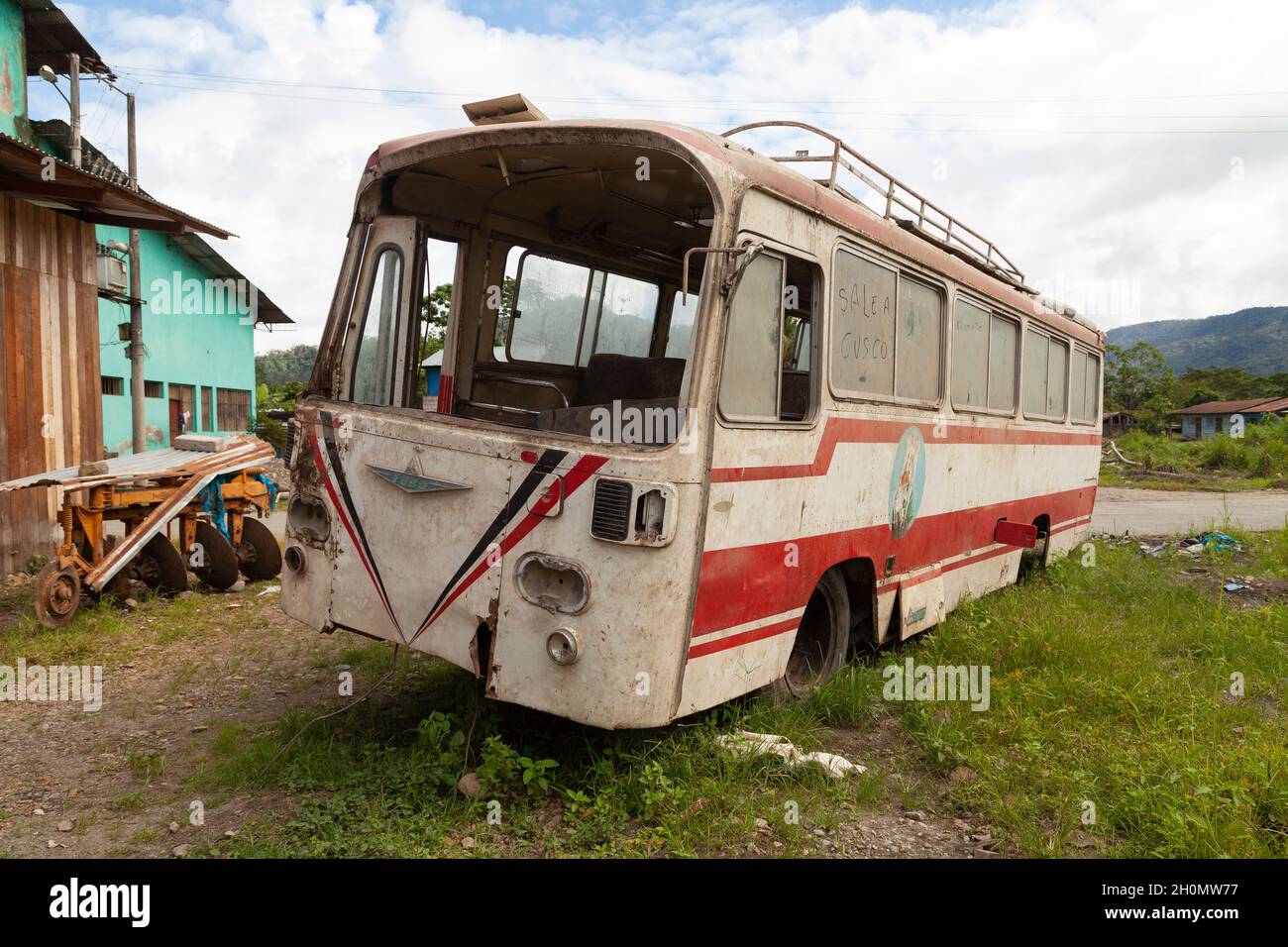 Pilcopata, Peru - April 12, 2014: An old, rusty, dusty and abandoned Fuso bus, rests in the surroundings of the small town of Pilcopata Stock Photo
