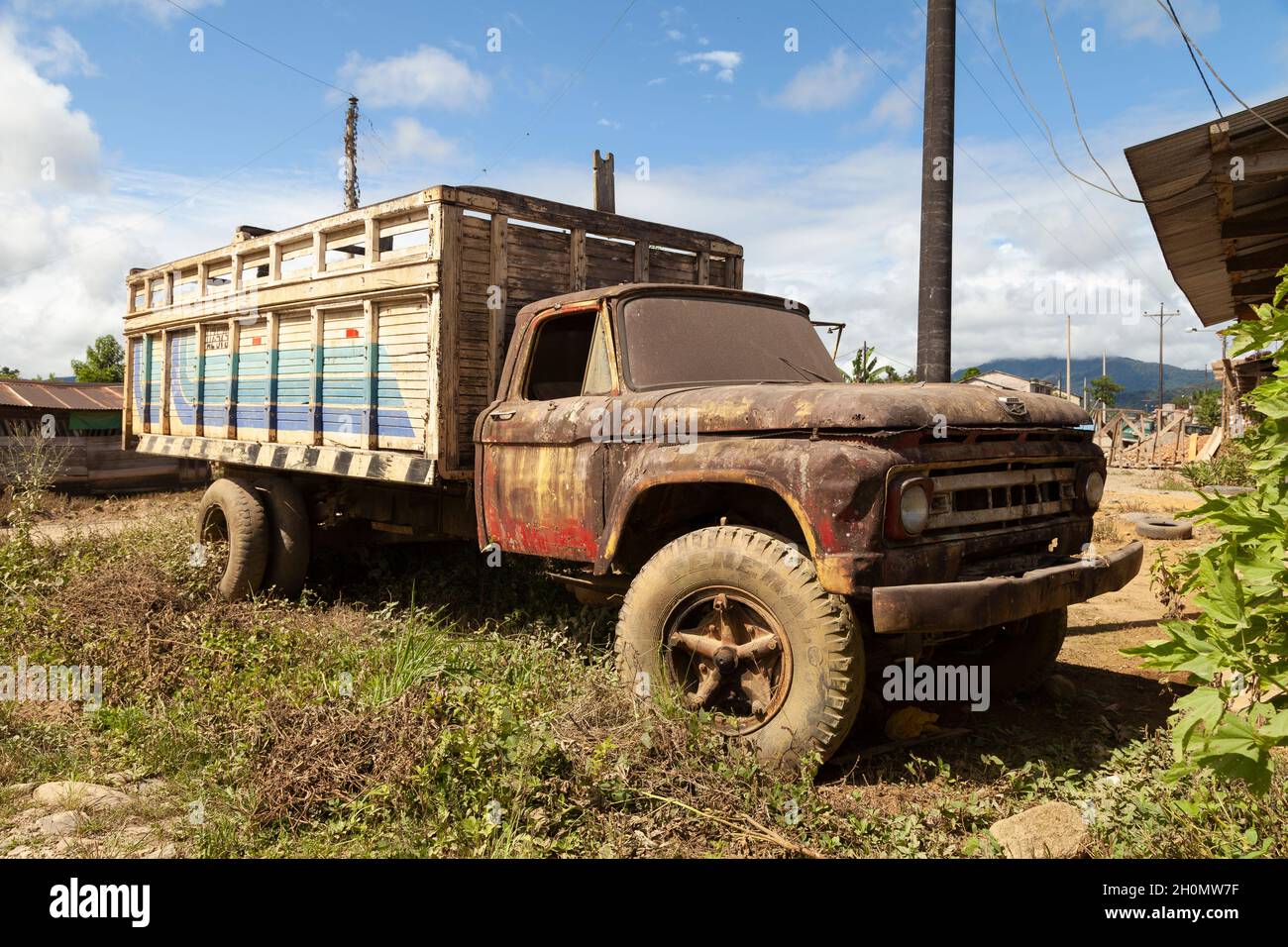 Pilcopata, Peru - April 12, 2014: An old, rusty and abandoned big truck, with veiled crystals, rests in the surroundings of the small town of Pilcopat Stock Photo