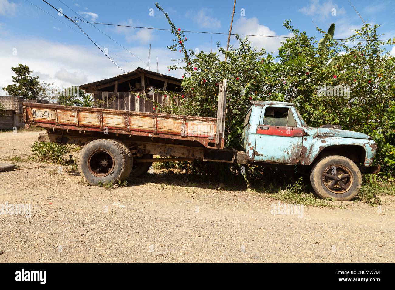Pilcopata, Peru - April 12, 2014: An old, rusty and abandoned Ford truck, painted blue, rests in the surroundings of the small town of Pilcopata Stock Photo