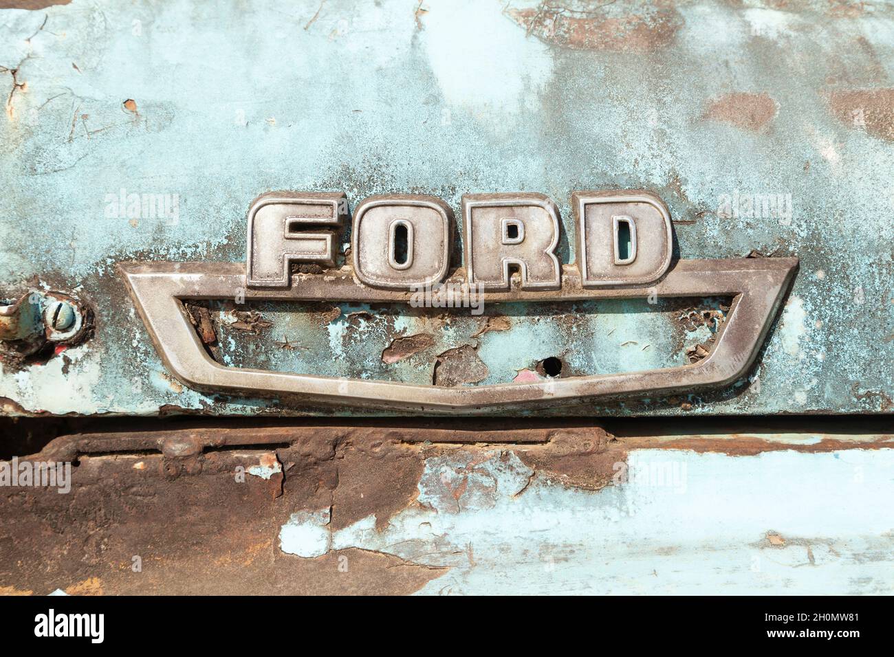 Pilcopata, Peru - April 12, 2014: Close-up logo of an old, rusty and abandoned Ford truck, in the surroundings of the small town of Pilcopata Stock Photo