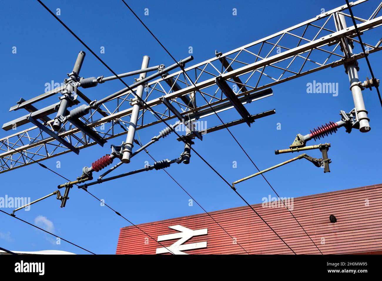 National Rail overhead electrical catenary wires supply for trains and British Rail Double Arrow, UK Stock Photo