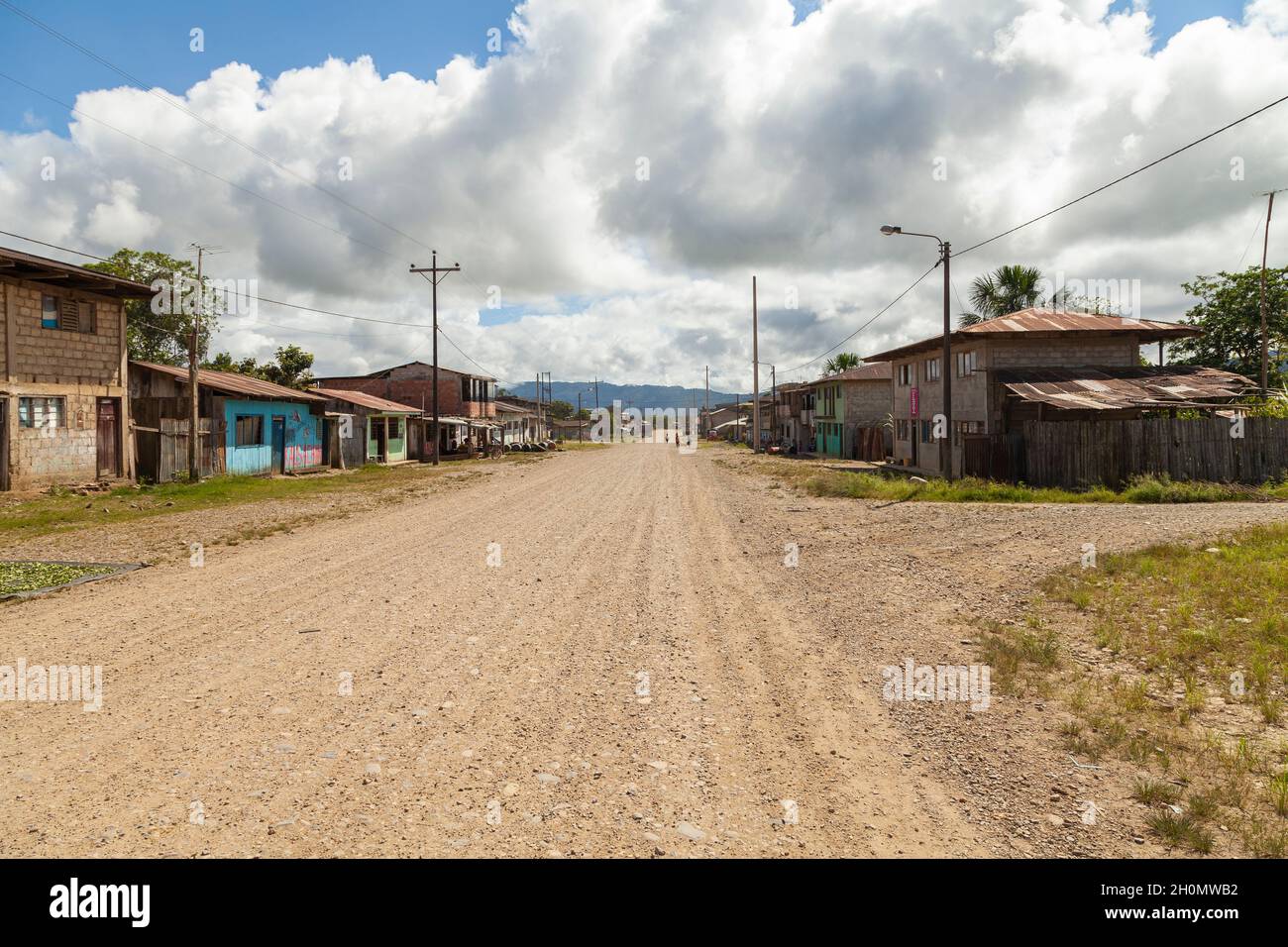 Pilcopata, Peru - April 12, 2014: Several houses in one of the neighborhoods of the small town of Pilcopata, line a dirt street Stock Photo