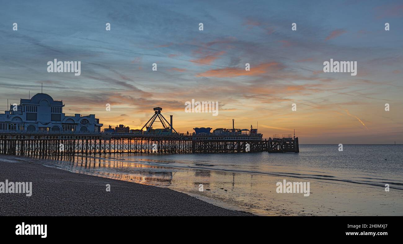 South Parade Pier on Southsea Beach at sunrise with a low tide and blue skies Stock Photo