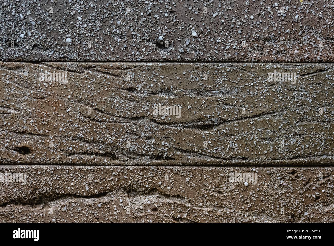 Close-up texture of a brown decorative scratched brick with a gap Stock Photo