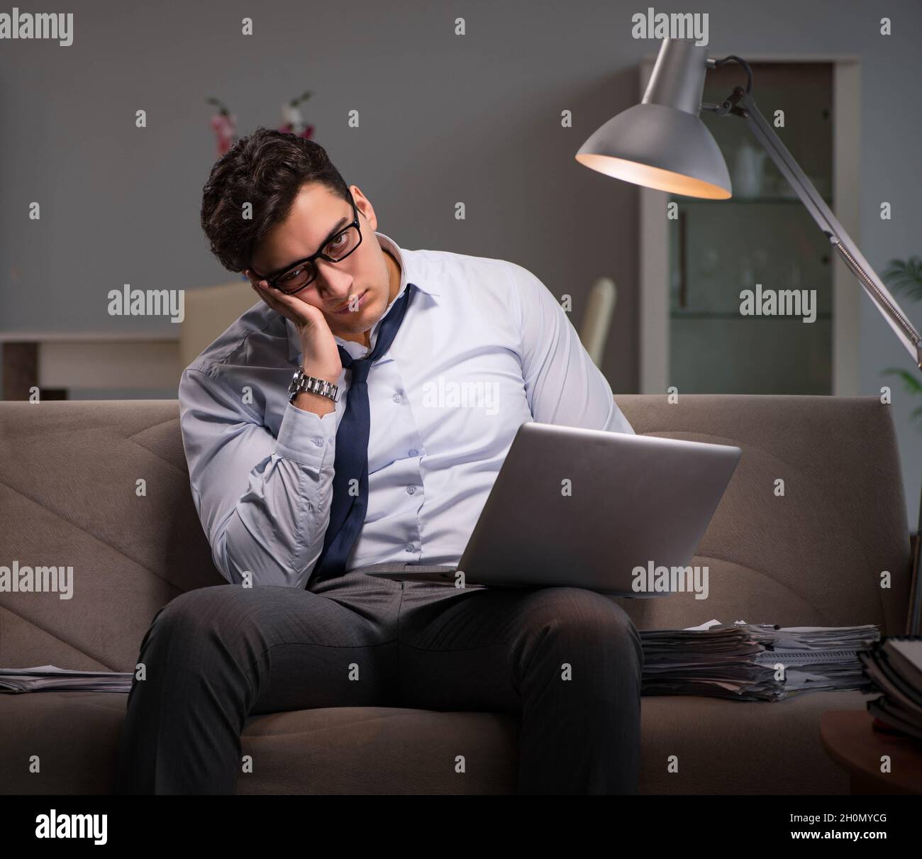 The businessman workaholic working late at home Stock Photo - Alamy