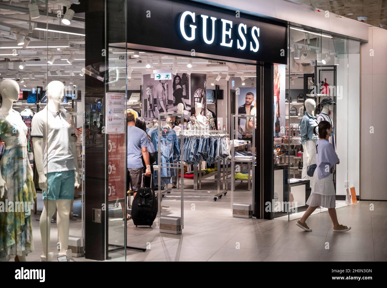 A shopper seen leaving the American clothing brand and retailer Guess store in Hong Kong's Tung Chung district. (Photo by Budrul Chukrut SOPA Images/Sipa USA Stock Photo - Alamy