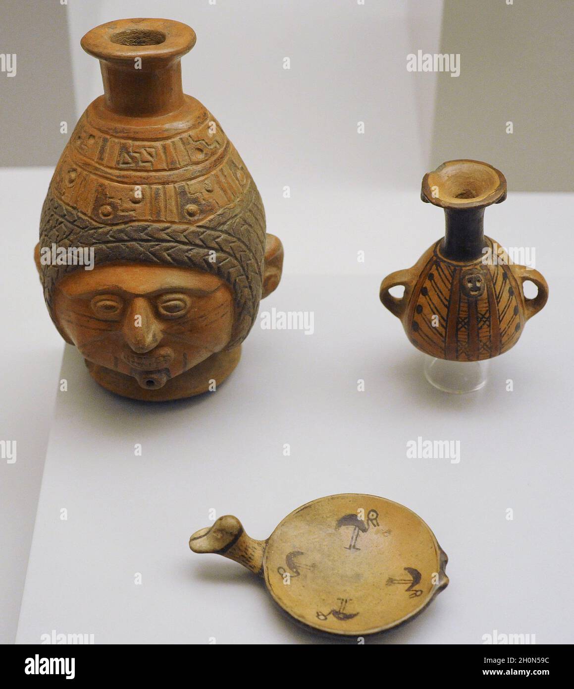 Inca civilization. Vessel in the shape of a human head. Plate decorated with wading birds (painted pottery). Aryballos with geometric decoration (pain Stock Photo