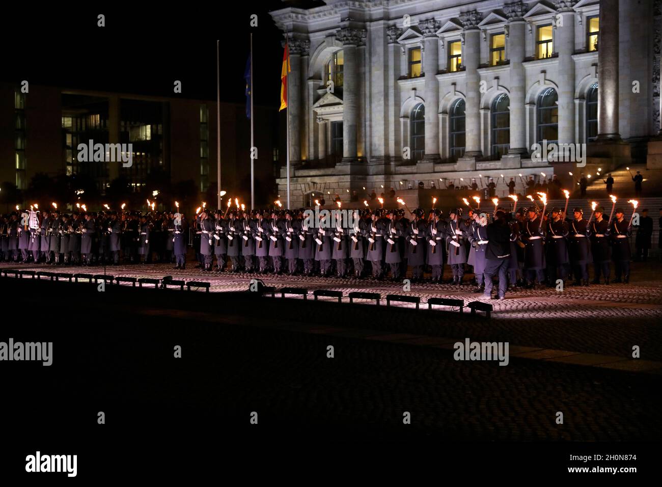 Berlin, Germany, 13th Oct, 2021.After almost twenty years, the Bundeswehr's mission in Afghanistan has finally come to an end as of August 27, 2021. The appreciation of the mission culminates with a Great Taps ceremony in front of the Reichstag in Berlin. The Great Taps is a solemn military ceremony held in the evening, performed by a special formation of military musicians, gunmen and torchbearers designated only for this purpose. Credit: Juergen Nowak / Alamy Live News. Stock Photo