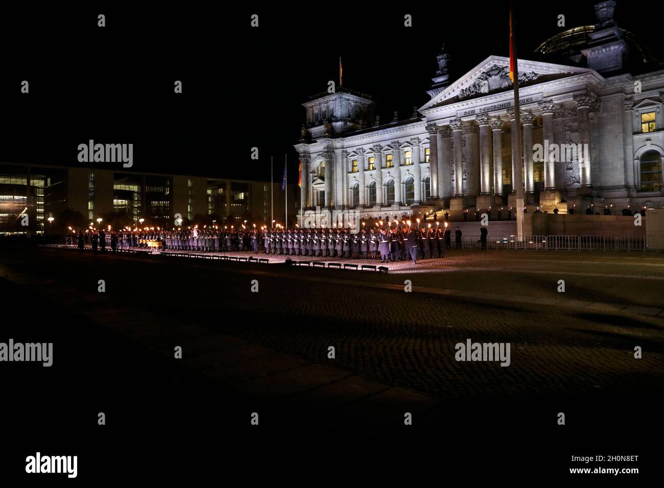 Berlin, Germany, 13th Oct, 2021.After almost twenty years, the Bundeswehr's mission in Afghanistan has finally come to an end as of August 27, 2021. The appreciation of the mission culminates with a Great Taps ceremony in front of the Reichstag in Berlin. The Great Taps is a solemn military ceremony held in the evening, performed by a special formation of military musicians, gunmen and torchbearers designated only for this purpose. Credit: Juergen Nowak / Alamy Live News. Stock Photo