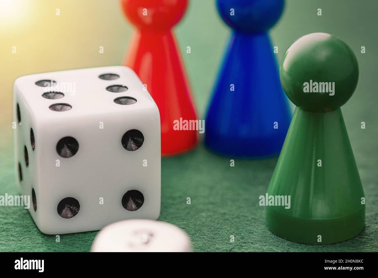 Colored board game figures with dice. Board games concept Stock Photo