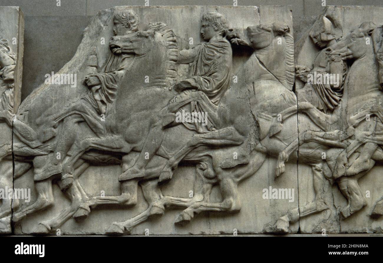 Slab of the North frieze of the Parthenon of Athens. Relief depicting three riders in the Procession of the Panathenaic festival, the commemoration of Stock Photo