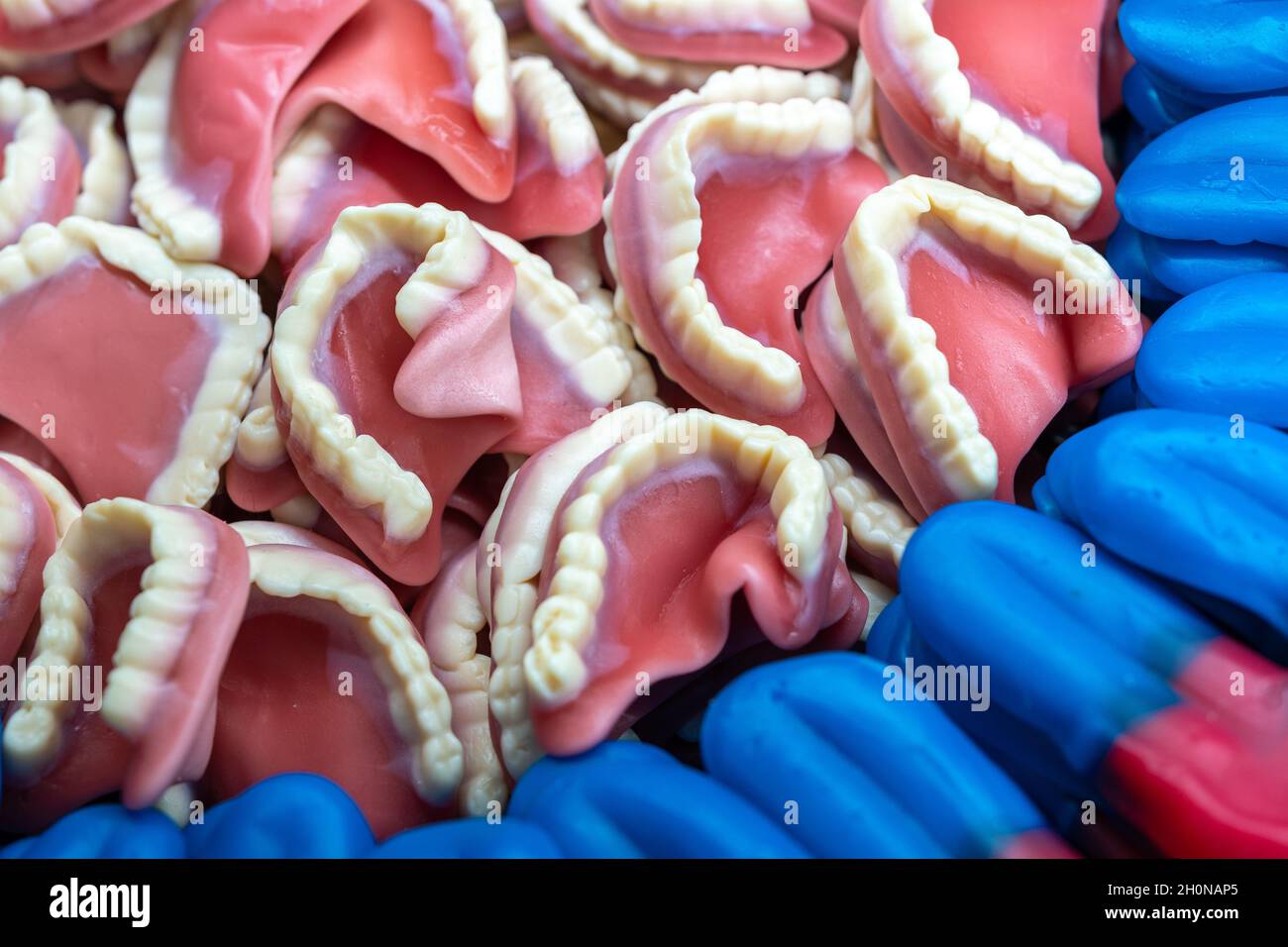 Colorful background made of sweet denture candies. Bright backdrop