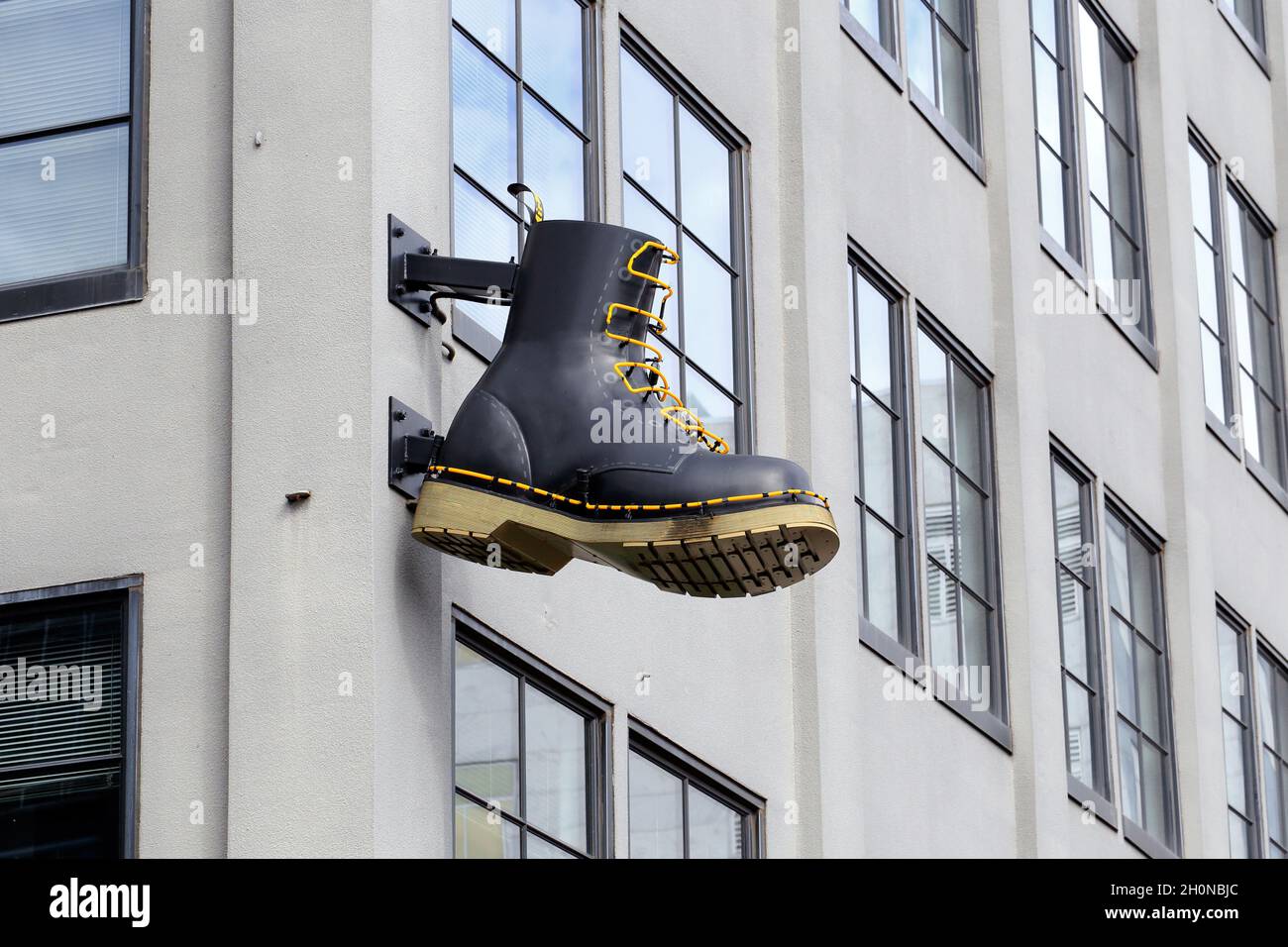 A Dr. Martens boot-shaped neon sign marquee at a store in Portland, Oregon. Stock Photo