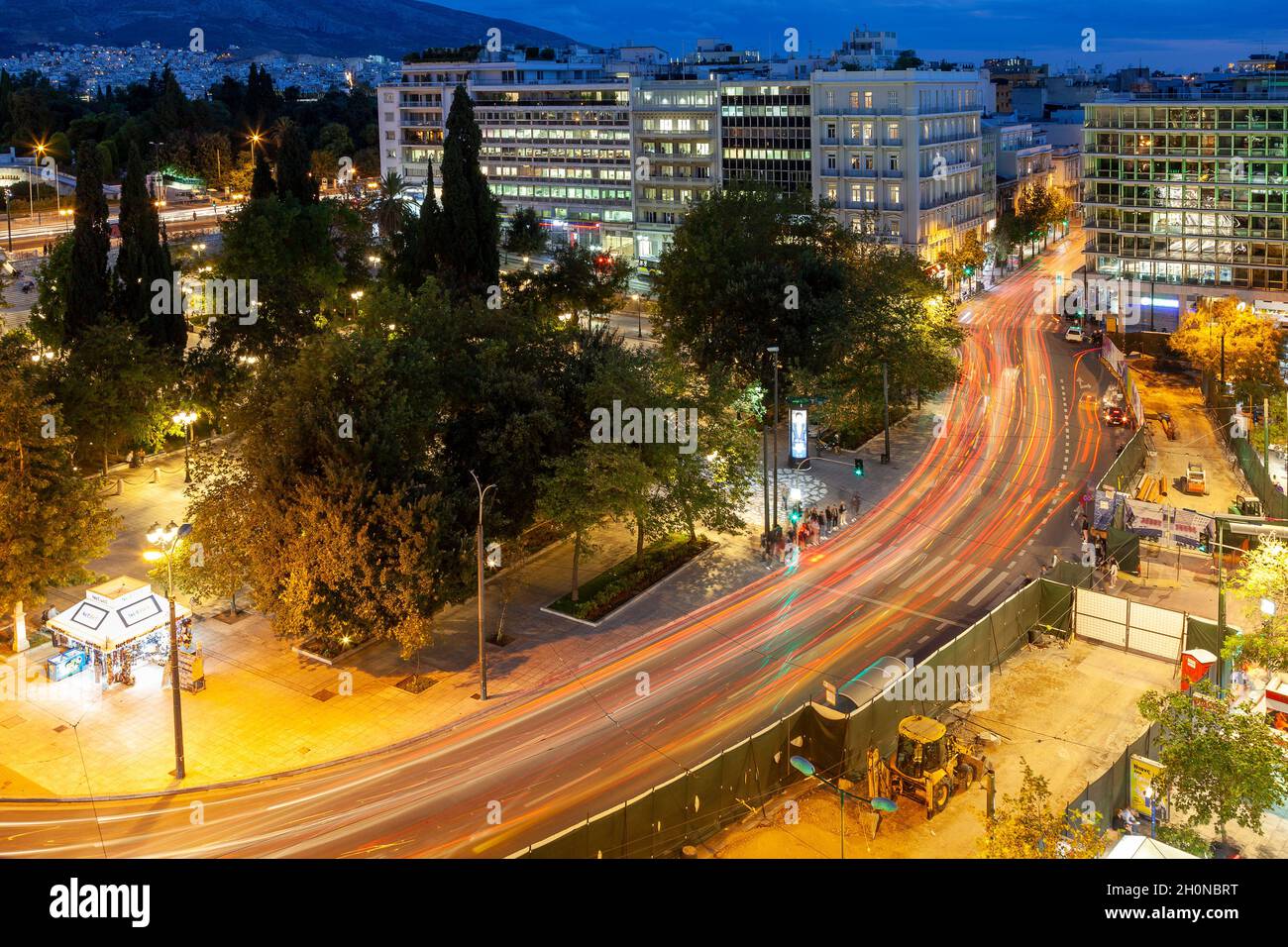 Syntagma Square, night view of the most iconic square of Athens, with car trails during the blue hour. At the right there are reform works undergoing. Stock Photo