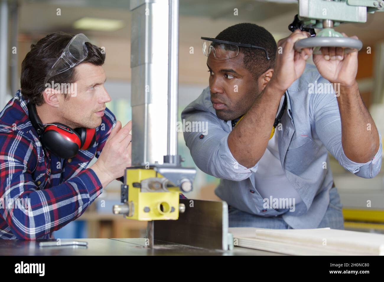 two designers working together in workshop with precision tools Stock Photo