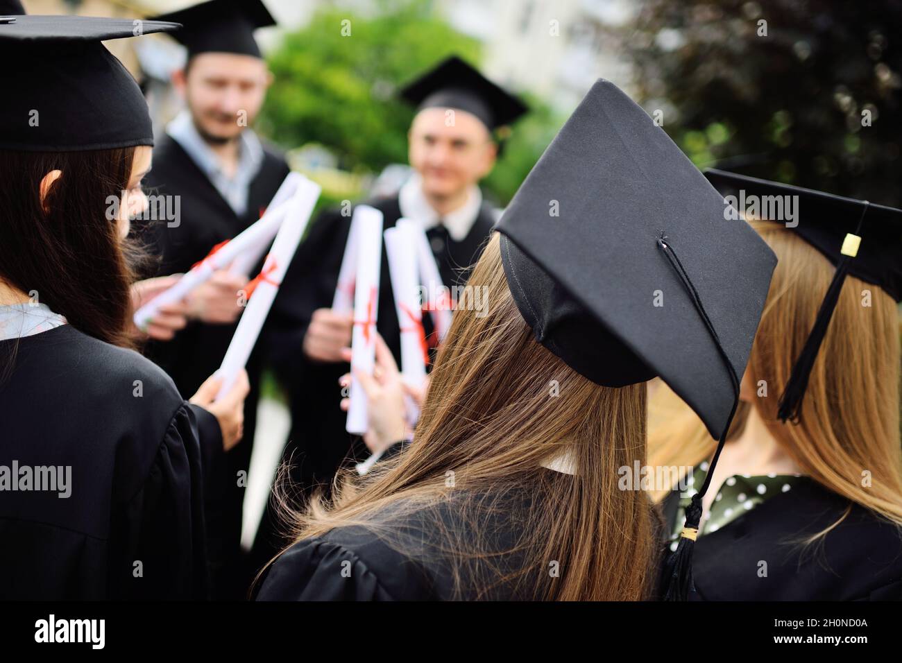 group of university graduates in student robes or mantle and square