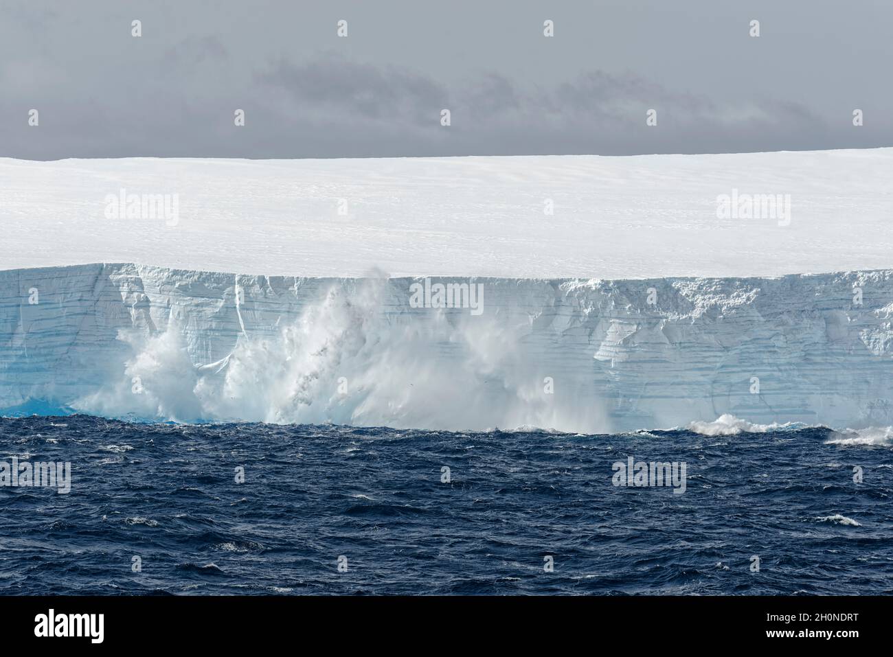 Tabular iceberg calving into the sea. Southern Ocean, Antartica Stock Photo