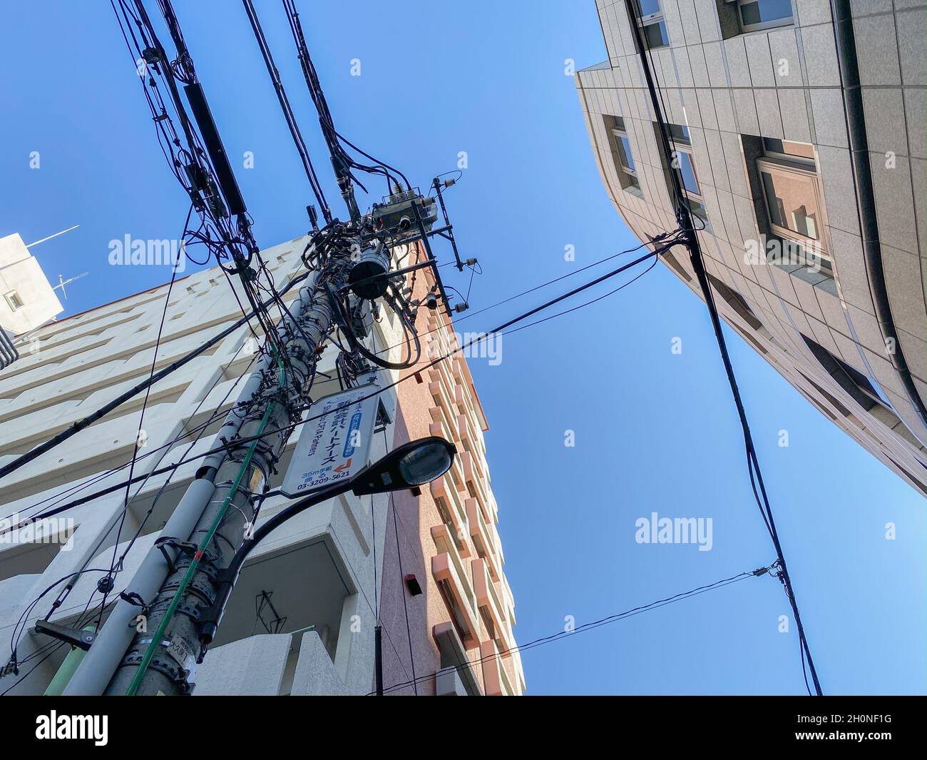 Tokyo, Japan - 21 November 2019: Electric poles in street in Tokyo Stock Photo