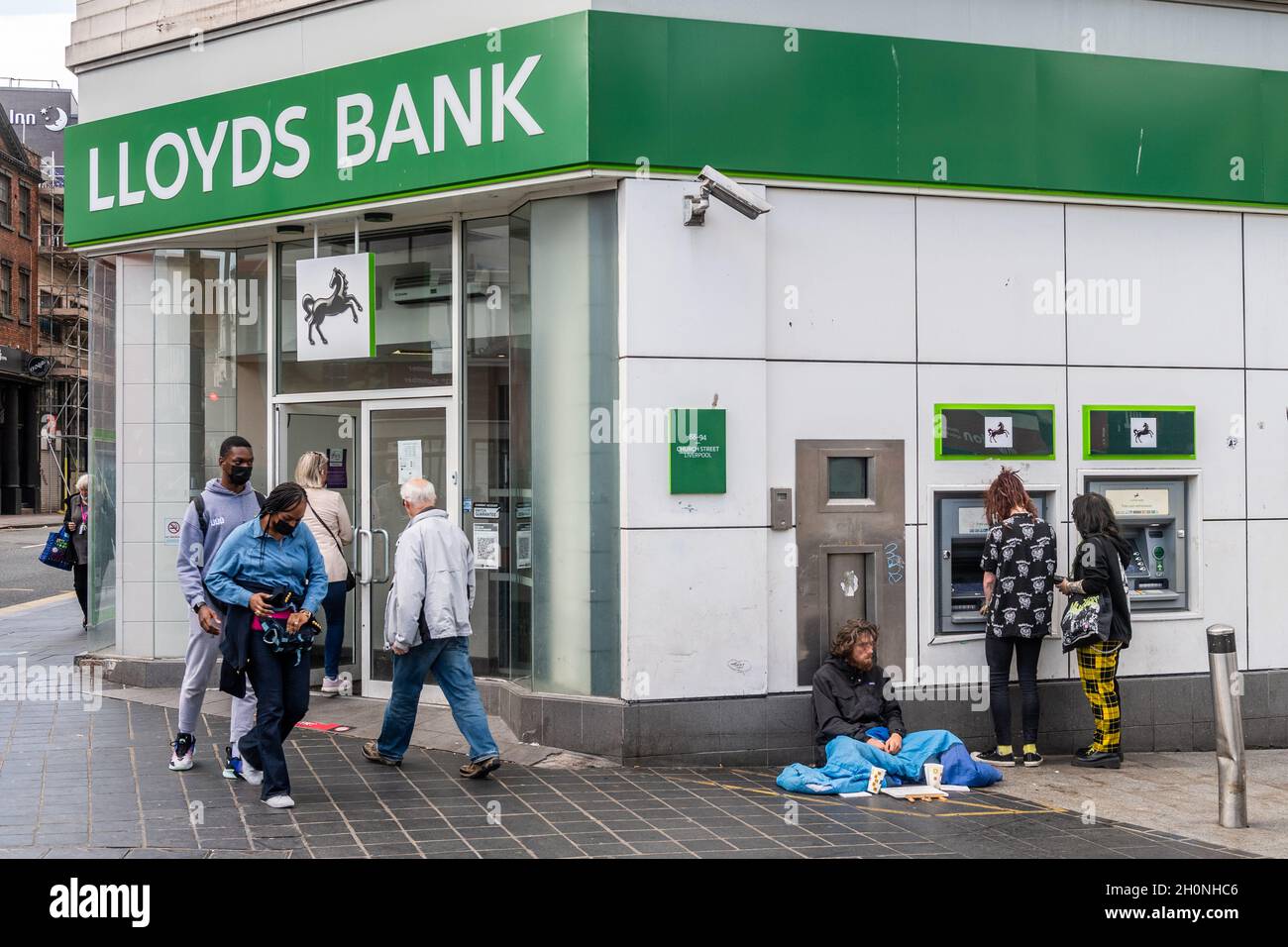 Homeless man begging outside Lloyds Bank, Church Street, Liverpool, Merseyside, UK. Stock Photo
