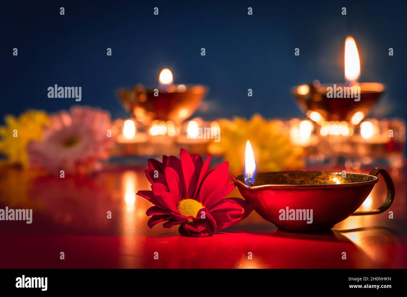 Happy Diwali. Burning diya oil lamps and flowers on blue background.  Traditional Indian festival of light. Celebrating religious holiday Stock  Photo - Alamy