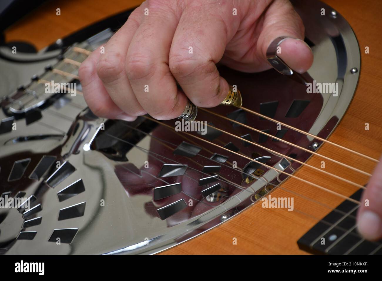 Male hand plays the Dobro for bluegrass music Stock Photo Alamy
