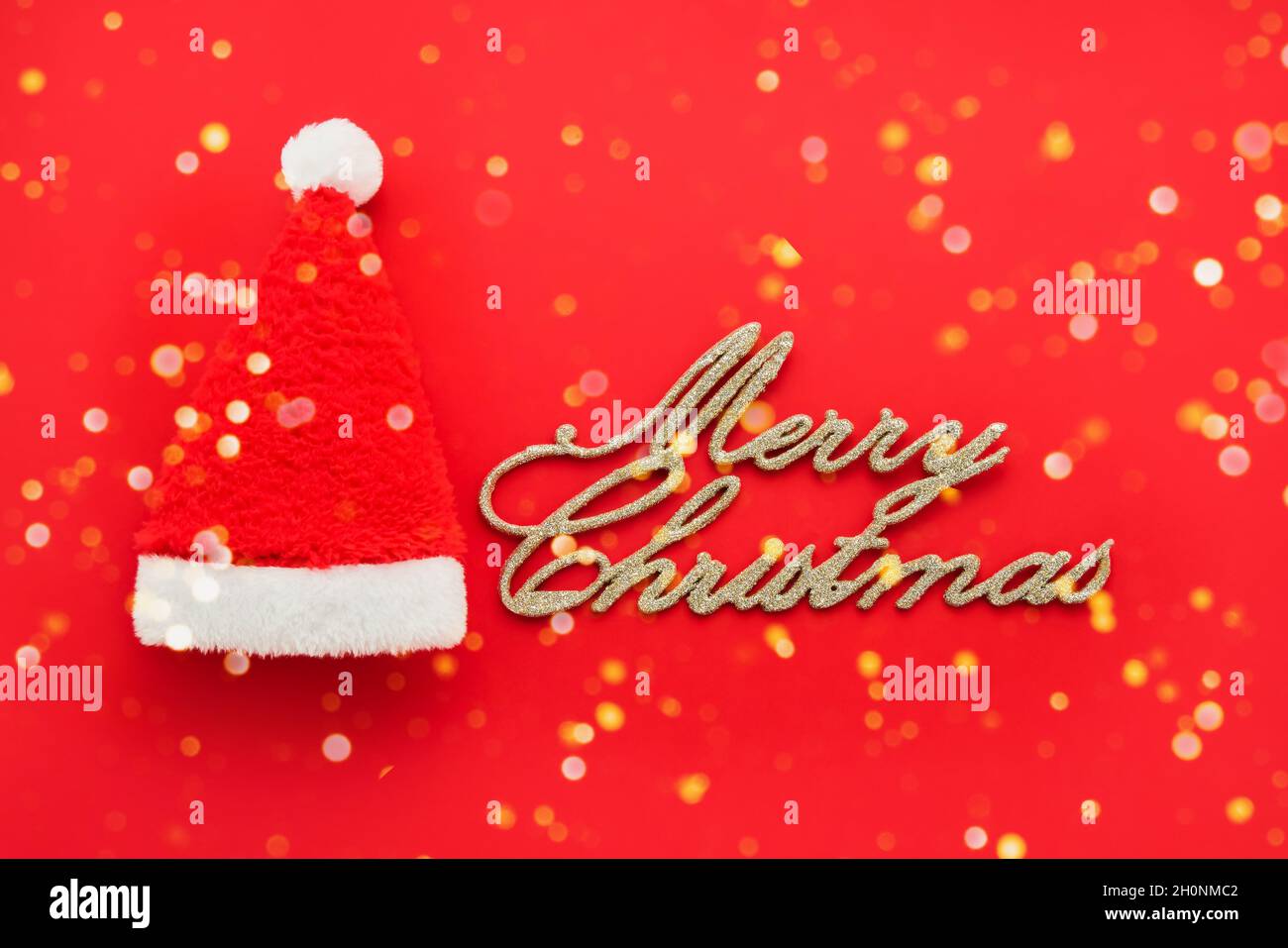 Christmas background. Text Merry Christmas and a small Santa hat on a ...